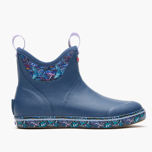 XTRATUF Women's Ankle Deck Boot in Fig, featuring a blue finish with vibrant abstract patterns on the collar and sole.