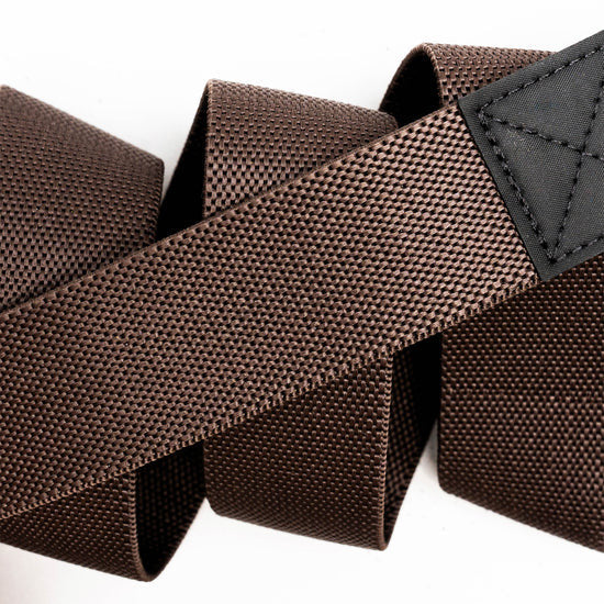 Brown woven Motion Stretch Belt from Arcade Belts, showing its textured fabric and durable stitching.