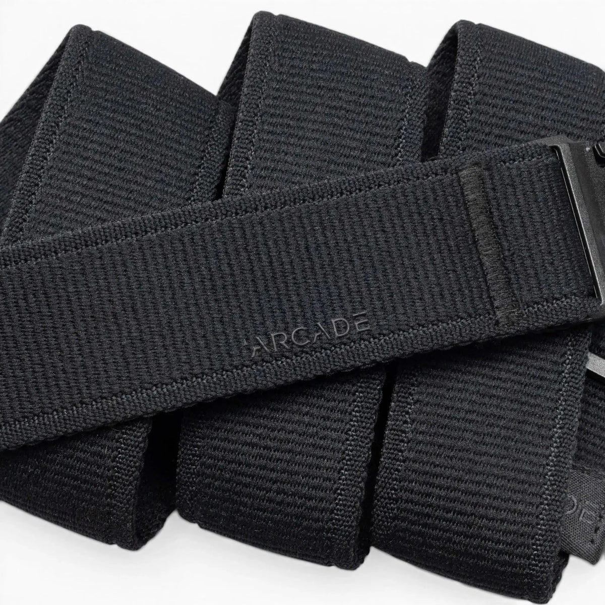 Arcade Atlas Stretch Belt, black woven elastic belt with black buckle and embossed Arcade logo.