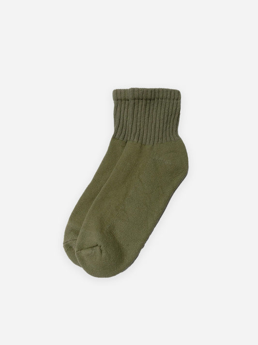 A pair of olive green The Solids Quarter Crew socks by American Trench, shown on a white background.