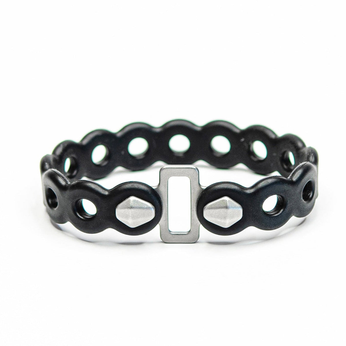 Infinity Tools 4-Pack | MODL black silicone bracelet with wavy links, holes, silver buckle, and faceted studs.