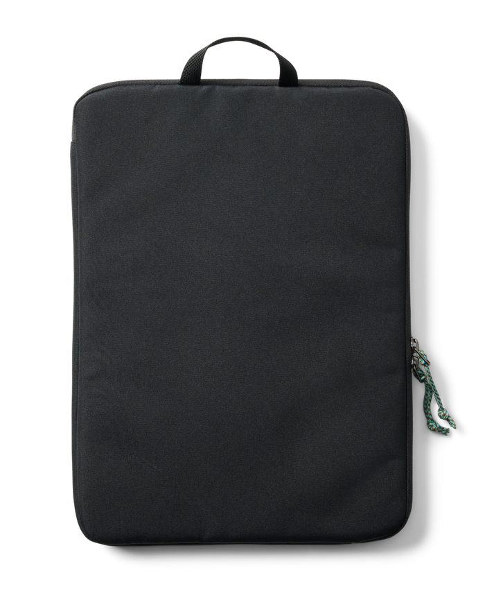 Cotopaxi Cada Dia 16-inch Laptop Sleeve in black, featuring a top handle and colorful zipper pull cord.