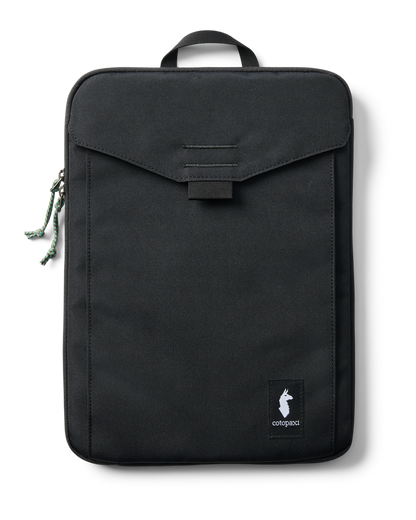 Black Cotopaxi Cada Dia 16-inch laptop sleeve with front pocket and green cord zipper pull on white background.