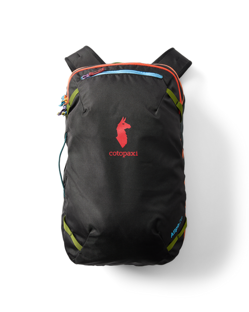 Cotopaxi Allpa 28L Travel Pack in black with red logo and colorful zippers, flat lay on a white background.