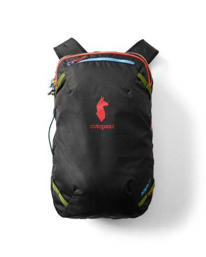 Cotopaxi Allpa 28L Travel Pack in black with red logo and colorful zippers, flat lay on a white background.