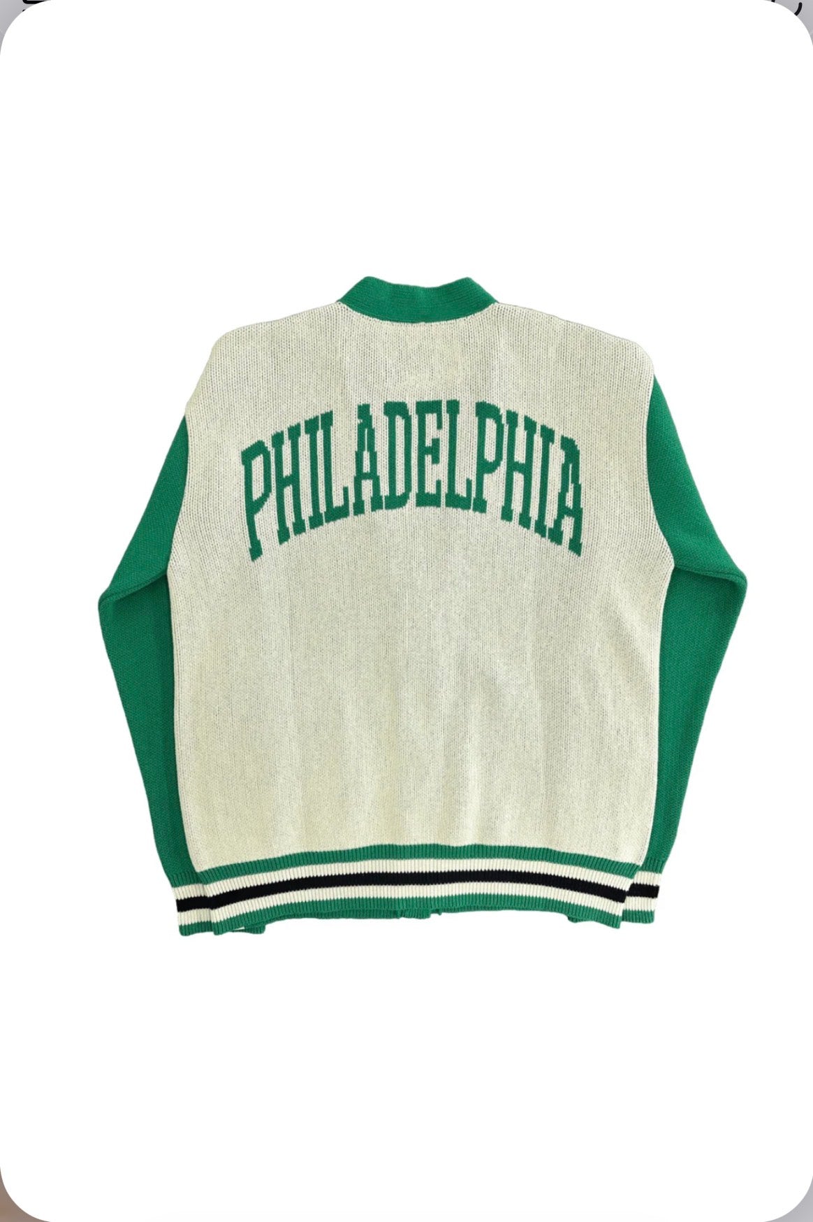 Back of Birds Eco Cardigan from Boathouse Sports, cream with green sleeves and 'PHILADELPHIA' in green on the back, striped trim.