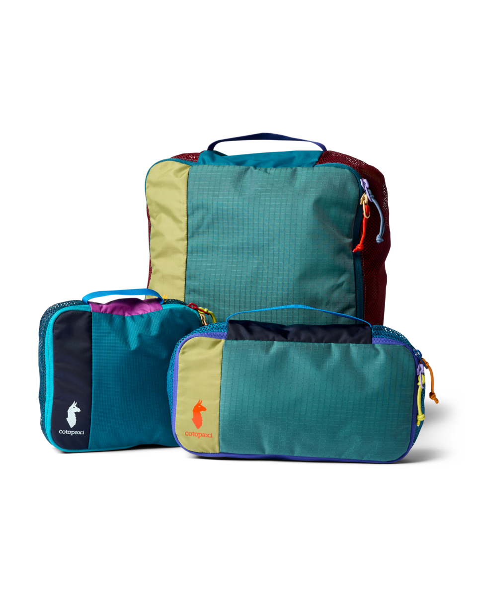 Cotopaxi Cubo Packing Travel Bundle with three colorful, geometric grid-patterned packing cubes on a white background.