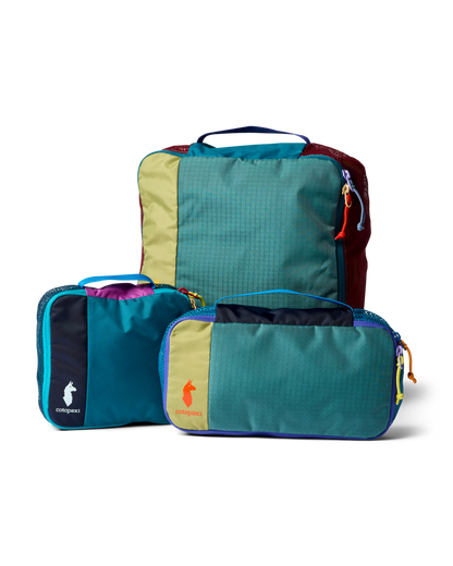 Cotopaxi Cubo Packing Travel Bundle with three colorful, geometric grid-patterned packing cubes on a white background.