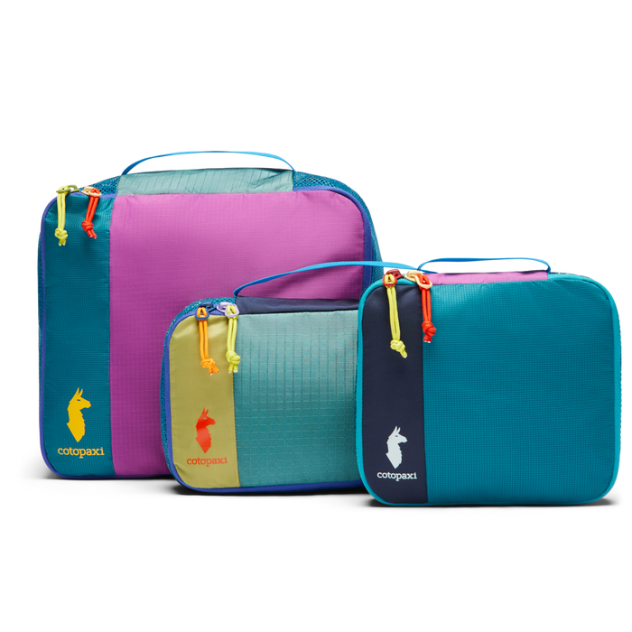 Cotopaxi Cubo Packing Travel Bundle: Three vibrant, multicolored packing cubes in different sizes for organized travel.
