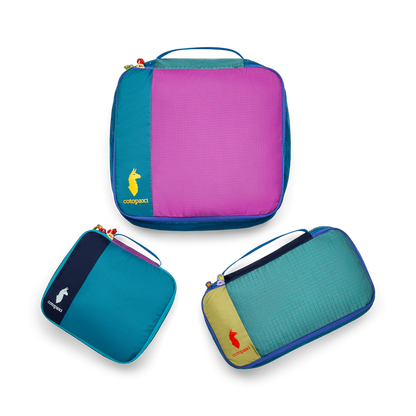 Cotopaxi Cubo Packing Travel Bundle, featuring three vibrant, multicolored packing cubes for organized travel.