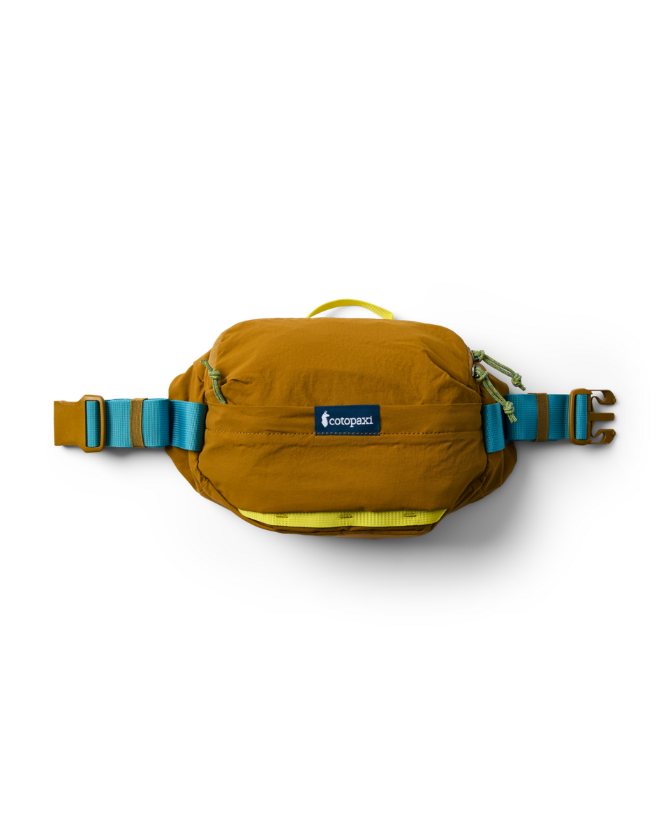 Cotopaxi Empacable 3L Sling in brown, featuring blue and yellow straps and green zipper pulls, studio shot.