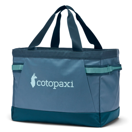 Cotopaxi Allpa 60L Gear Hauler Tote in blue-green, a durable and versatile carry bag with handles and logo.
