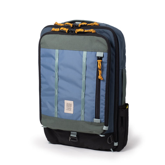 Global Travel Backpack by Topo Designs in blue, green, and black, front view, with yellow zipper pulls