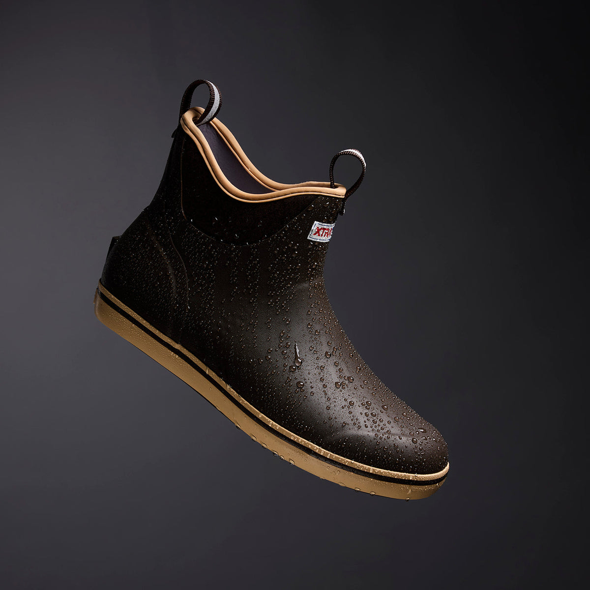 XTRATUF Men's Ankle Deck Boot Sport in brown, waterproof and ready for action, covered in water droplets.