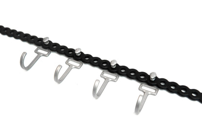 Close-up of HookStuds™ | MODL, a black modular strap with multiple silver hooks and studs, on a white background.