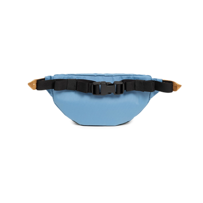 Topo Designs Mountain Waist Pack in light blue, featuring black adjustable straps and a secure buckle closure, presented on a black background.