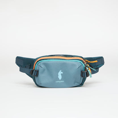 Cotopaxi Allpa X 1.5L Hip Pack in teal and orange, featuring the llama logo on the front pocket.