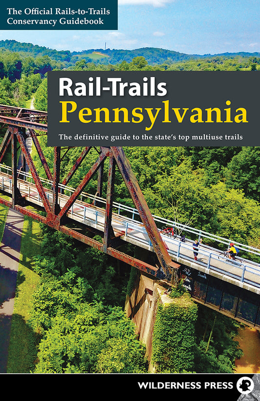 Cover of Rail-Trails Pennsylvania | Media Mercantile guidebook, showing cyclists on a scenic trail bridge over a lush forest.