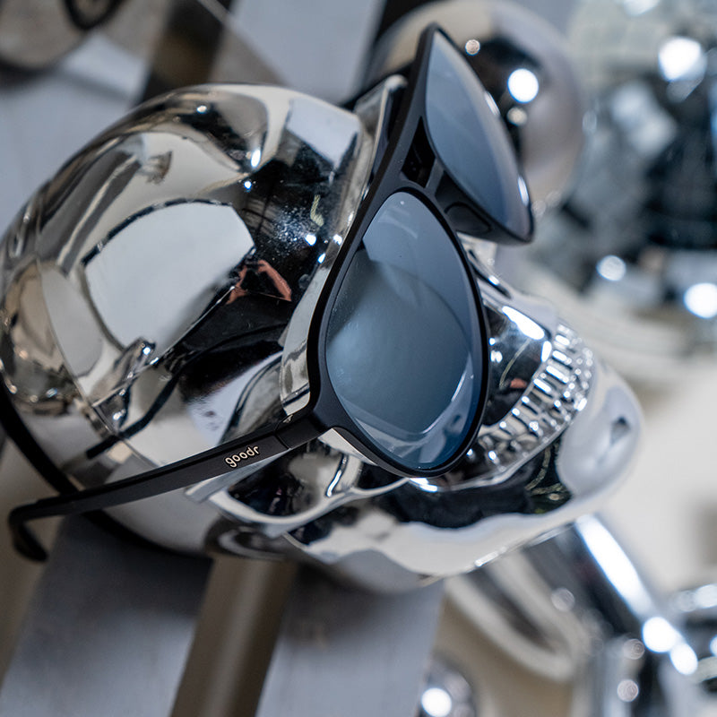 goodr Add the Chrome Package sunglasses with dark gray lenses on a shiny chrome skull.