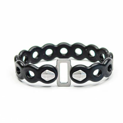 Infinity Tools 4-Pack | MODL black silicone bracelet with wavy links, holes, silver buckle, and faceted studs.