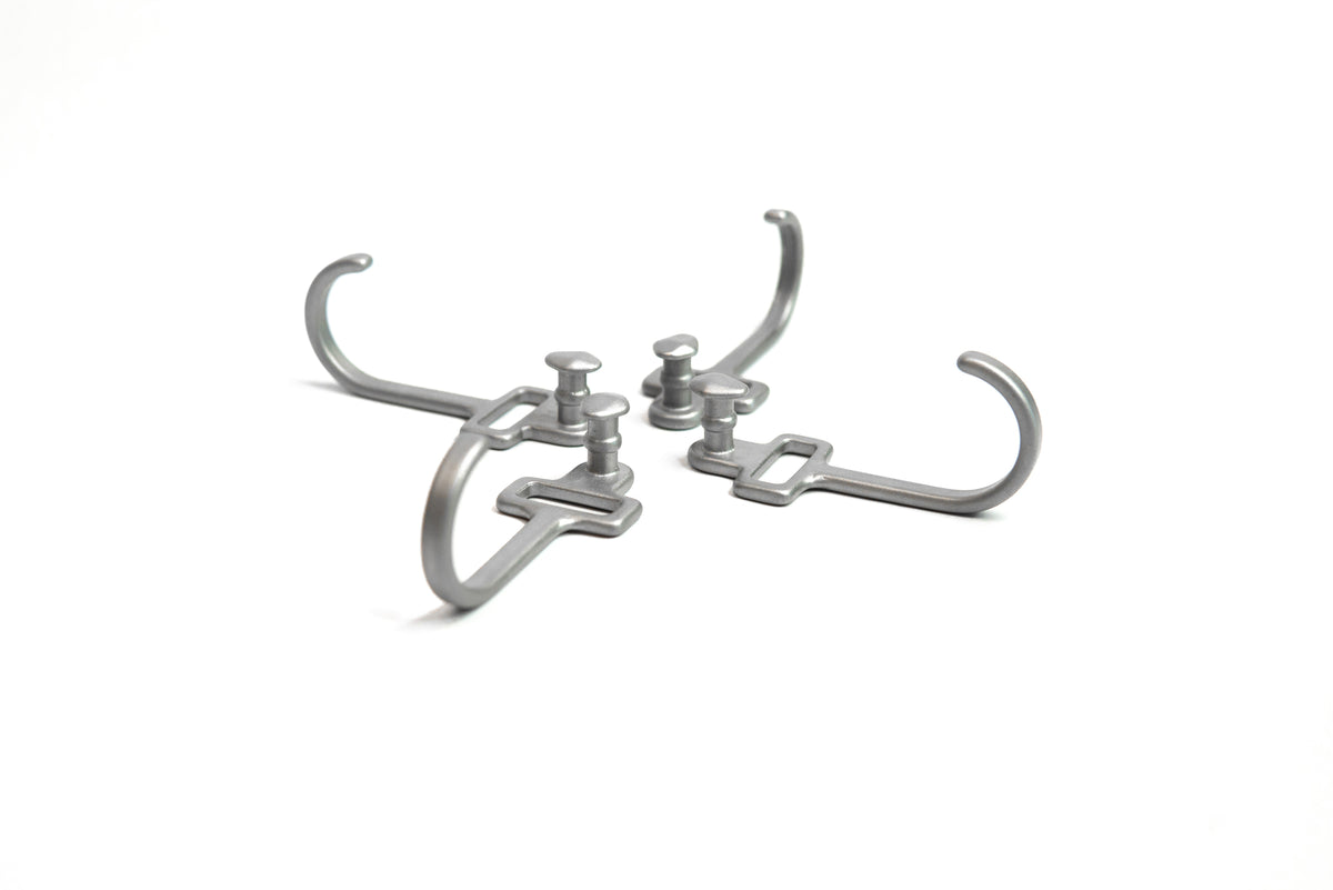 HookStuds™ | MODL in metallic grey, featuring four modular hooks with integrated studs, arranged symmetrically on a white background.