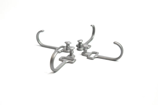 HookStuds™ | MODL in metallic grey, featuring four modular hooks with integrated studs, arranged symmetrically on a white background.