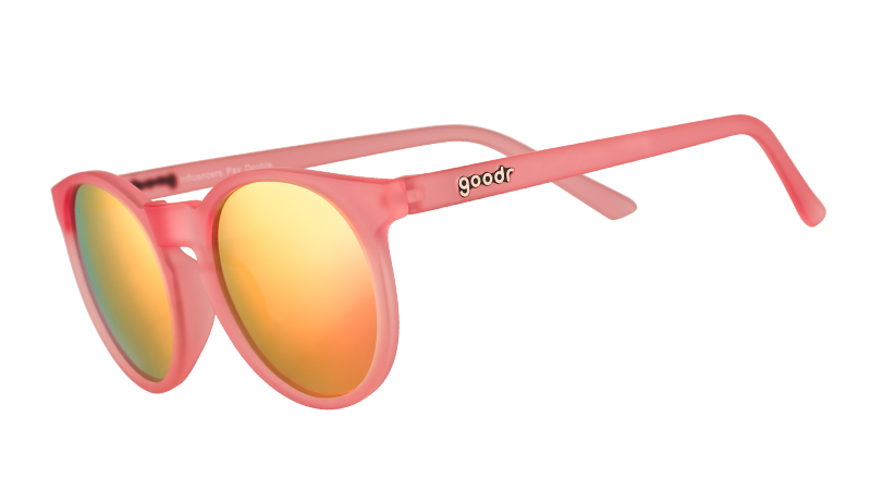 goodr 'Influencers Pay Double' sunglasses featuring a pink frame and vibrant orange mirrored lenses, shown at an angle.