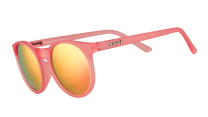 goodr 'Influencers Pay Double' sunglasses featuring a pink frame and vibrant orange mirrored lenses, shown at an angle.