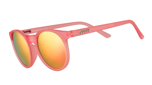 goodr 'Influencers Pay Double' sunglasses featuring a pink frame and vibrant orange mirrored lenses, shown at an angle.