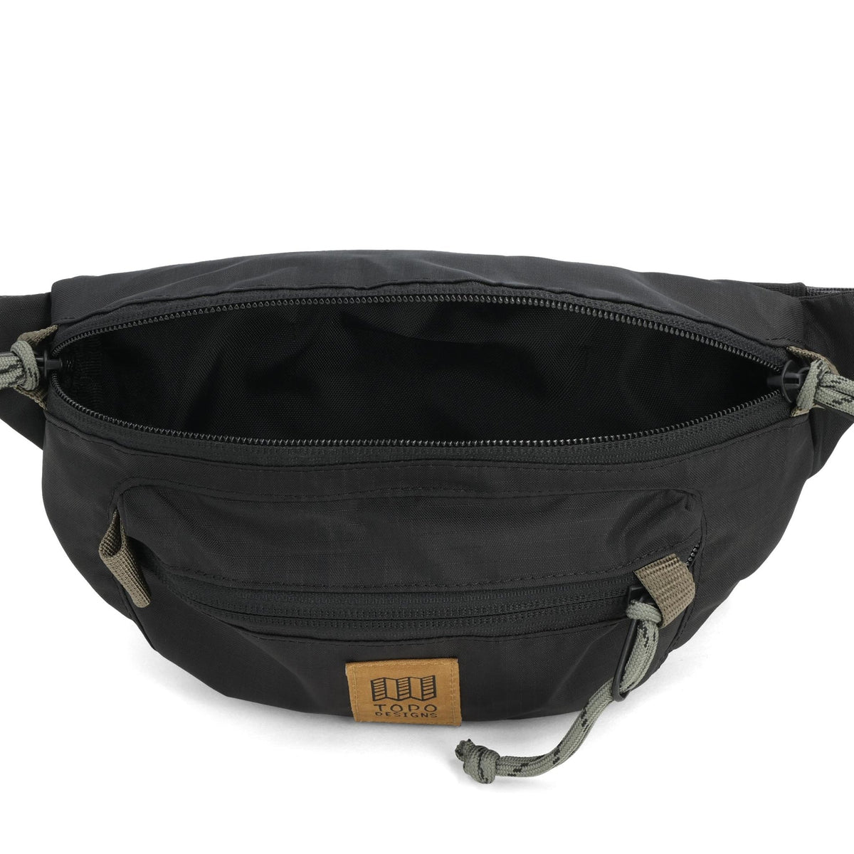 Topo Designs Mountain Waist Pack in black, open, showing the main compartment and front zippered pocket.