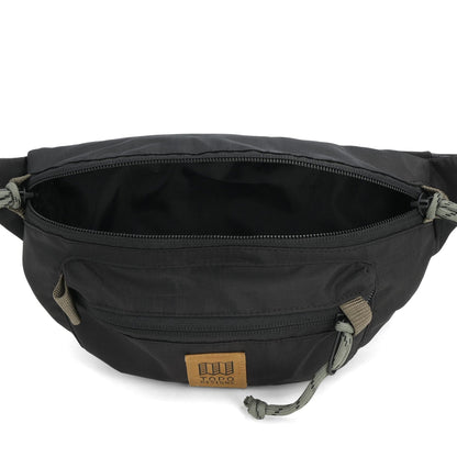 Topo Designs Mountain Waist Pack in black, open, showing the main compartment and front zippered pocket.