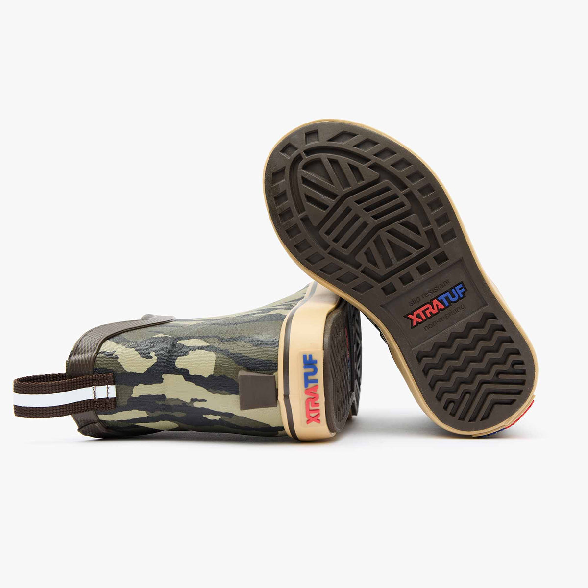 Kids' Mossy Oak Bottomland Ankle Deck Boot from XTRATUF, showing two boots with camo pattern and sole detail.