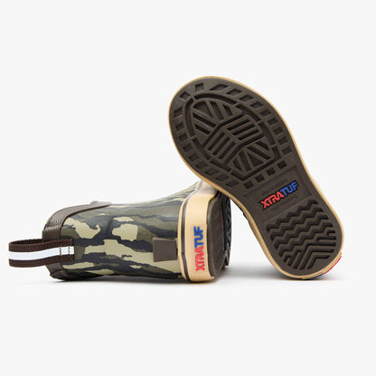 Kids' Mossy Oak Bottomland Ankle Deck Boot from XTRATUF, showing two boots with camo pattern and sole detail.