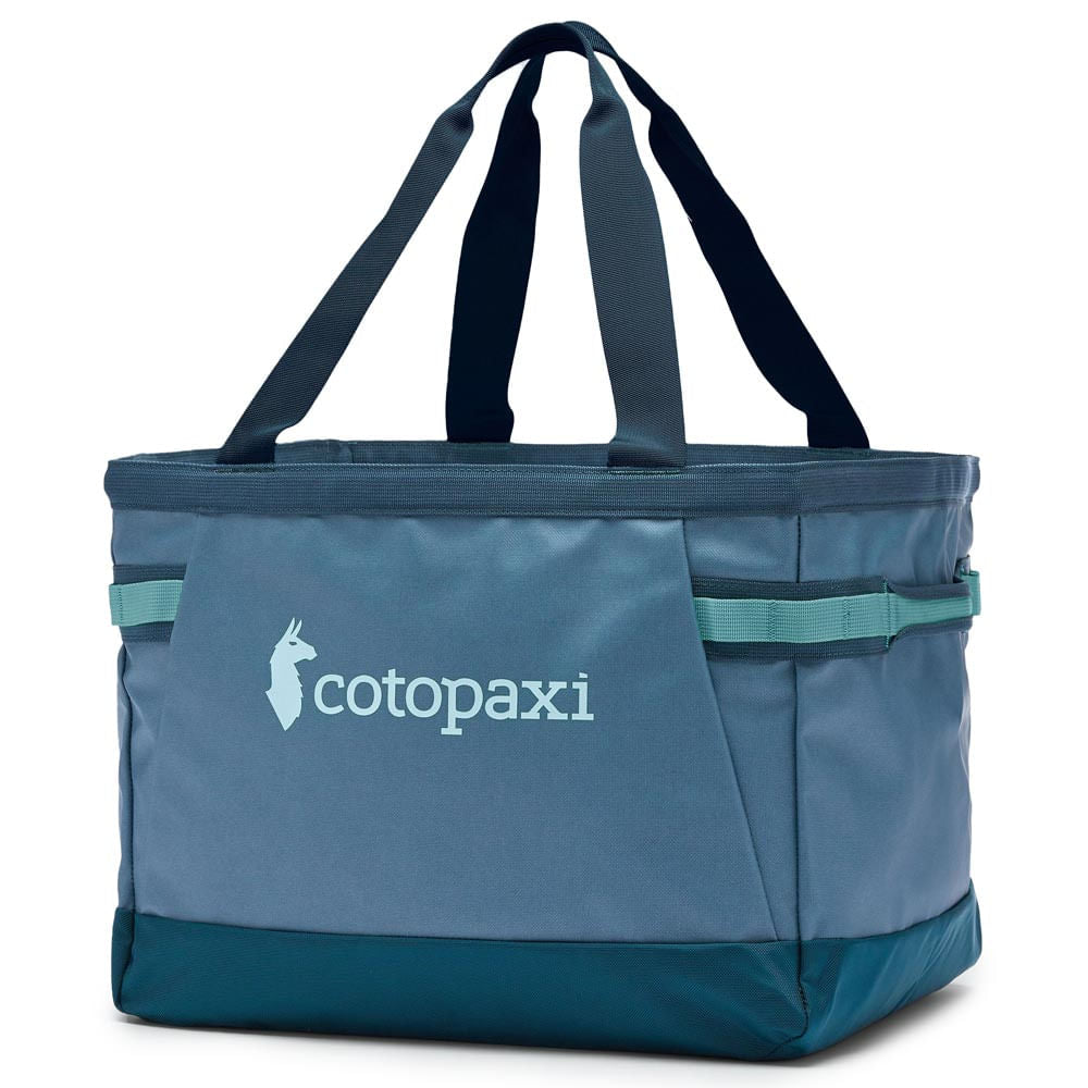 Cotopaxi Allpa 30L Gear Hauler Tote in blue and teal, with two dark blue handles and Cotopaxi logo.