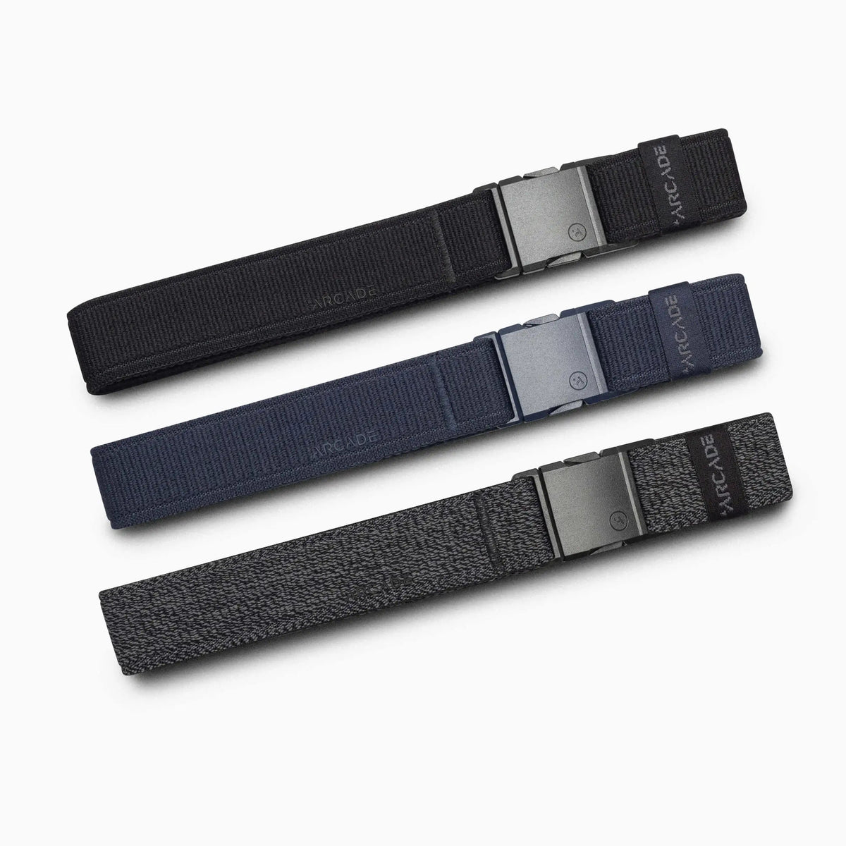 Arcade Belts Twilight Stretch Belt in black, navy blue, and dark grey heather, laid flat on a white background.