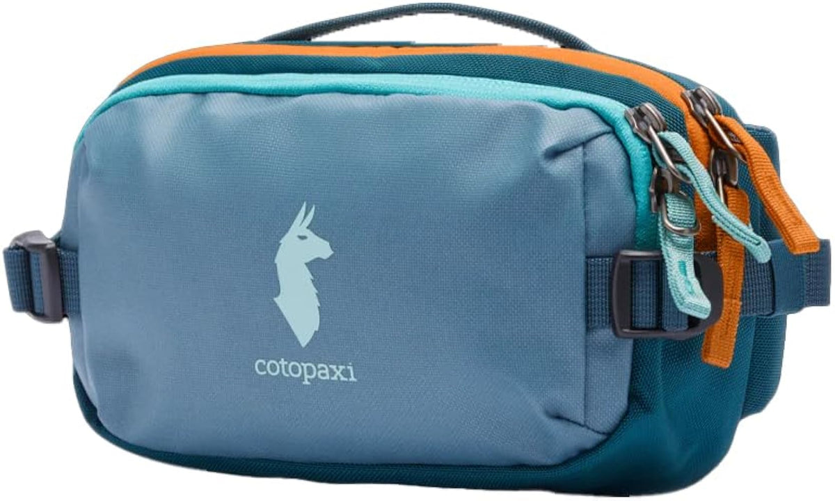 Cotopaxi Allpa X 1.5L Hip Pack in blue-grey with orange & blue accents, features llama logo and zip closures.