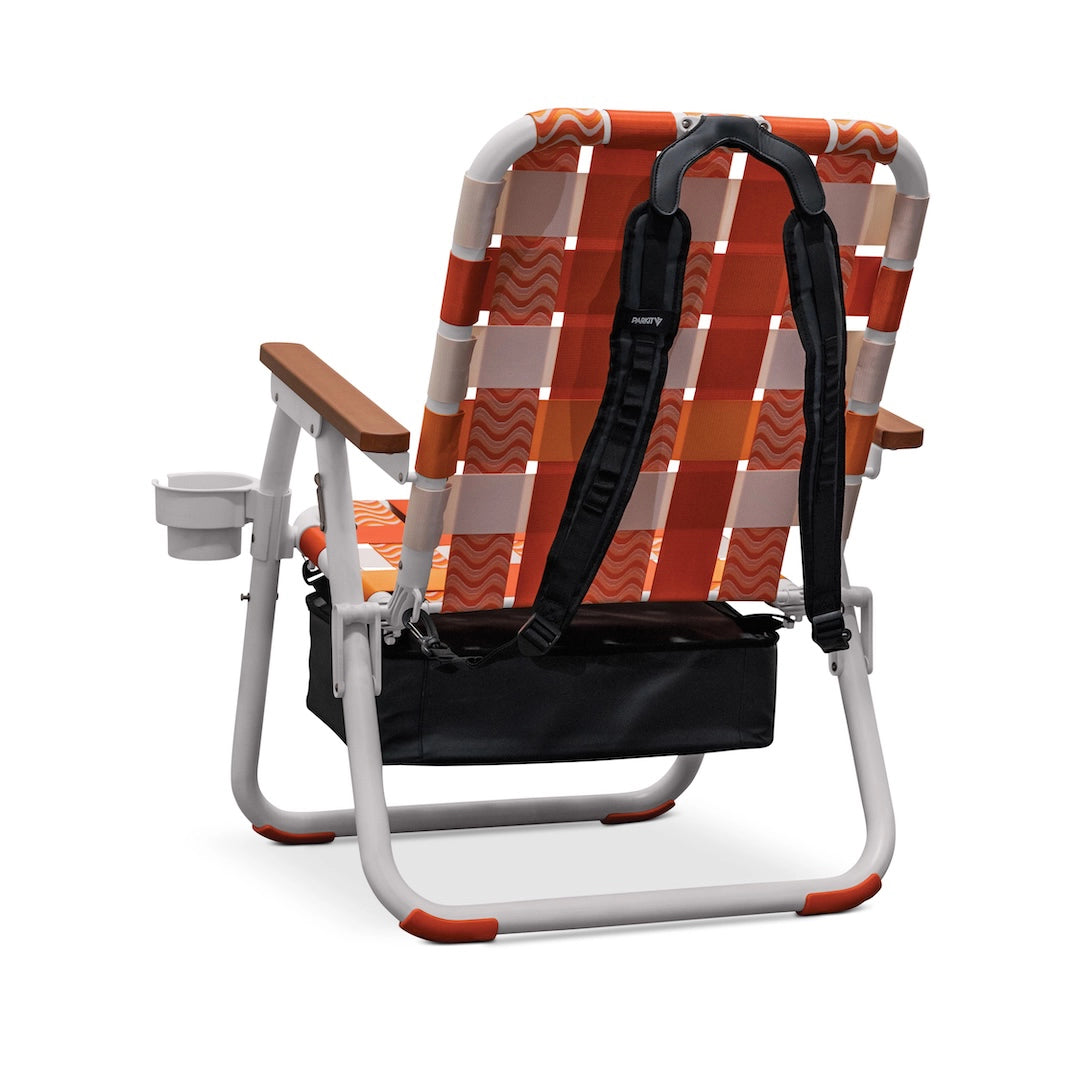 PARKIT Voyager Sunkissed portable beach chair, rear view, with orange/white pattern, backpack straps, cooler bag, cup holder.
