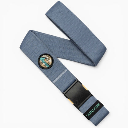 Arcade Belts Save the Waves Stretch Belt in blue, featuring a distinctive wave and sun patch and a black buckle.
