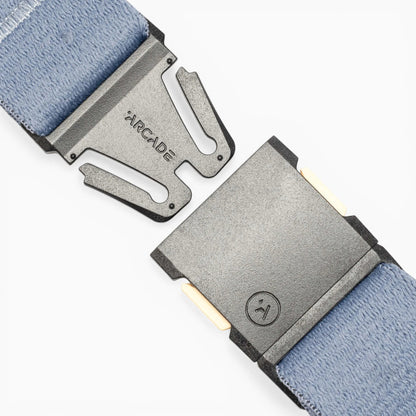 Close-up of the unbuckled gray buckle and light blue stretch webbing of the Save the Waves Stretch Belt by Arcade Belts.