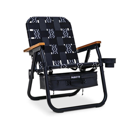 PARKIT Voyager Outdoor Chair with black and white patterned fabric, wooden armrests, under-seat storage, and cup holder.