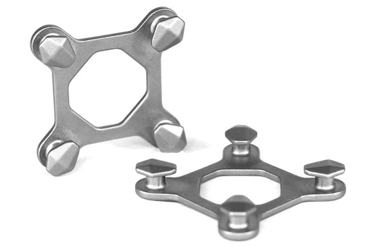 OmniLinks™ | MODL connectors, two metallic four-pronged brackets with hexagonal studs on a white background.