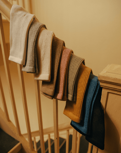 Ribbed Women's Statement Ankle in Cashmere socks by American Trench in multiple colors on a wooden stair railing.