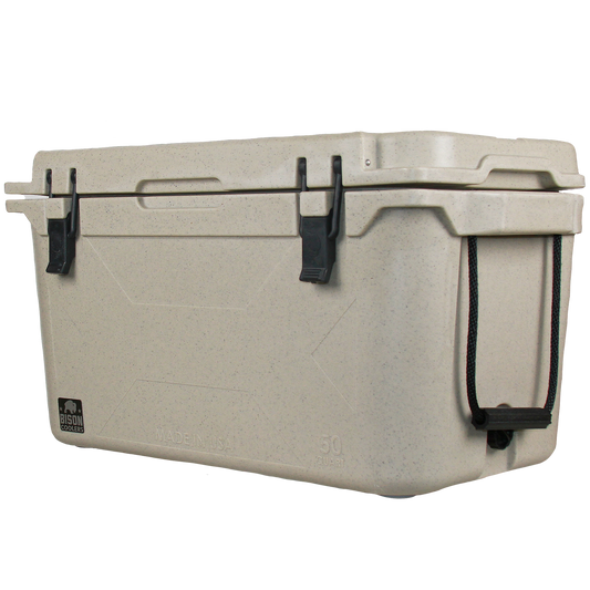 50 QT Bison Cooler by Bison Coolers in tan with black latches and rope handles, embossed "MADE IN USA" on a black background.