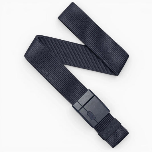 Arcade Belts Aero Mag Stretch Belt in dark grey with a magnetic buckle, coiled and displayed on a white surface.