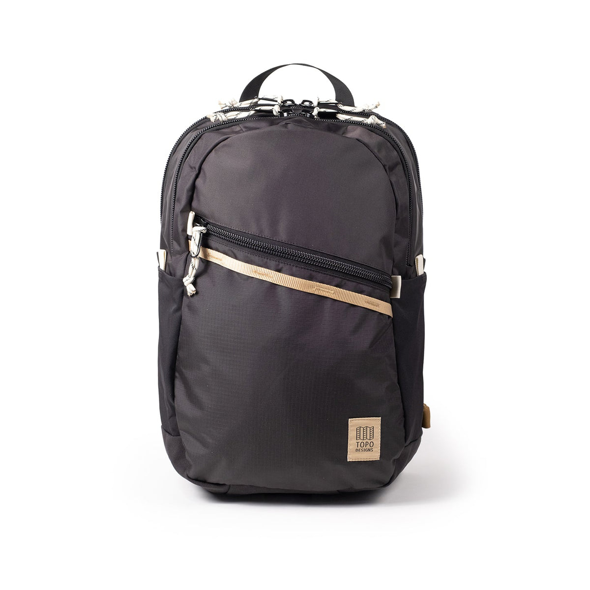 Topo Designs Commuter Backpack in black with tan accent strap, front zipper pocket, and Topo Designs logo.
