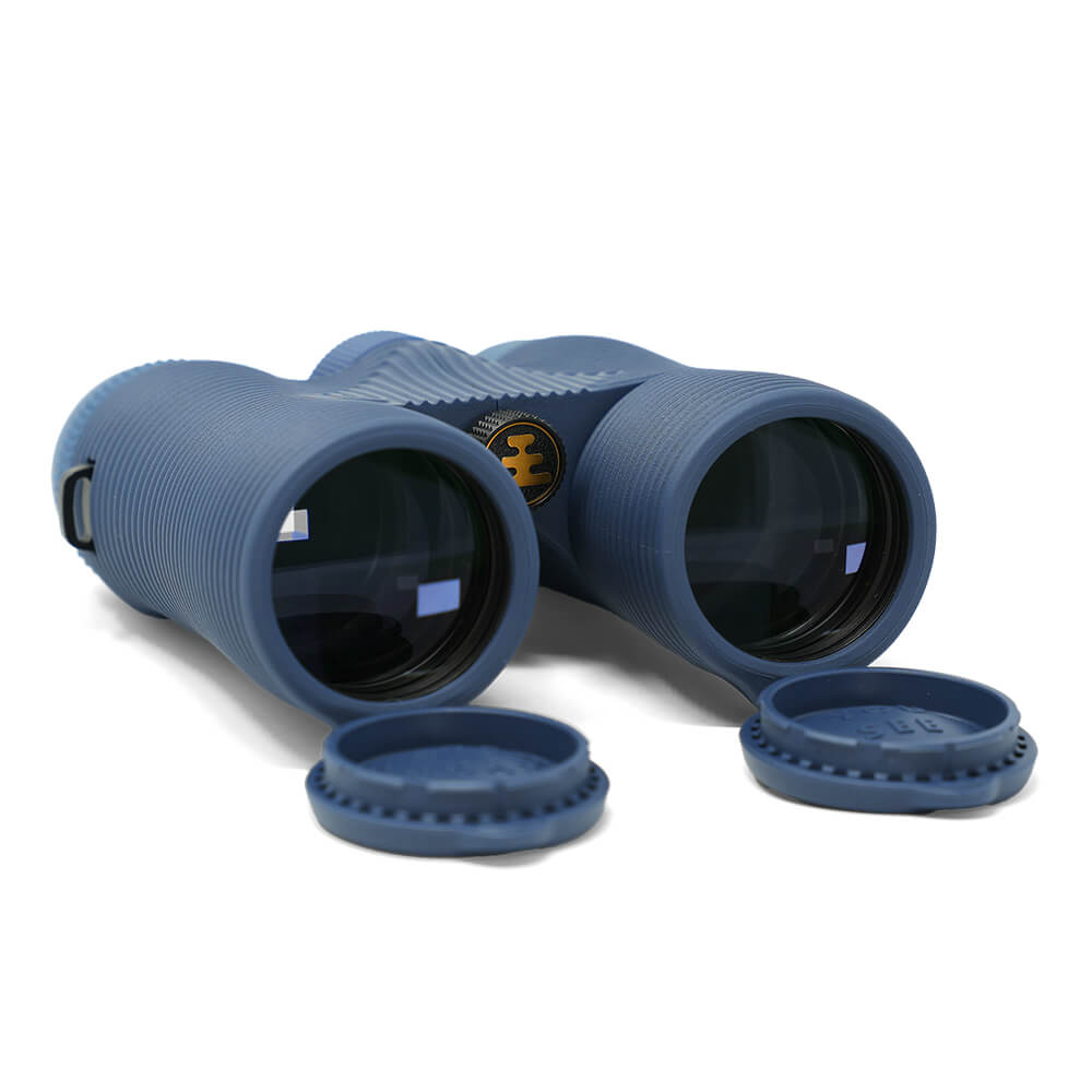 Field Issue 8x42 Binoculars by Nocs Provisions in dark blue, with lens caps, on a white background.