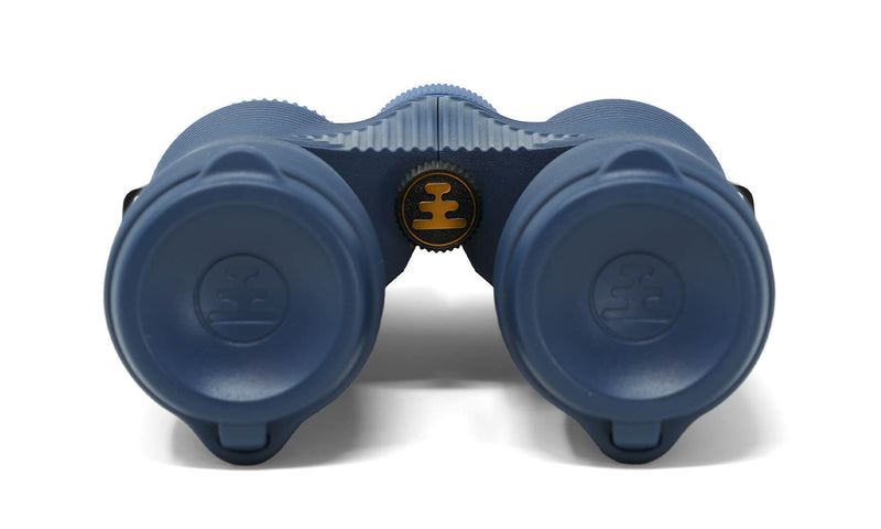 Front view of Nocs Provisions Field Issue 8x42 Binoculars in blue on a white background, with focus wheel logo
