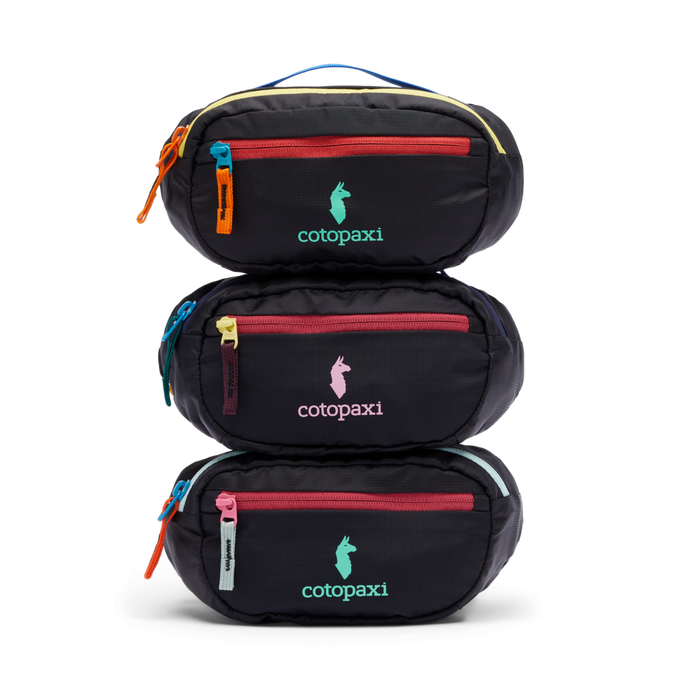 Stack of three black Cotopaxi Kapai 1.5L Hip Packs with colorful zippers and logos on a white background.