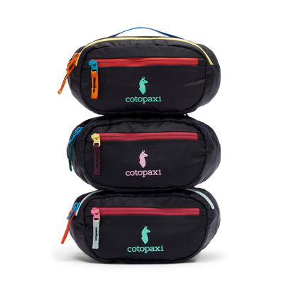 Stack of three black Cotopaxi Kapai 1.5L Hip Packs with colorful zippers and logos on a white background.