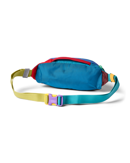Cotopaxi Kapai 1.5L Hip Pack, multi-color fanny pack with blue, red, yellow, green straps & purple buckle.